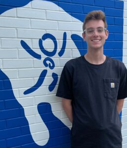 Picture of Jayden Holzaepfel - Museum Assistant - standing in front of museum.