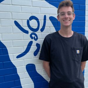 Picture of Jayden Holzaepfel - Museum Assistant - standing in front of museum.