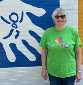 Picture of Mary Ann Hopple - Program Coordinator - standing in front of museum.