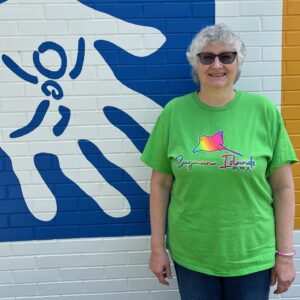 Picture of Mary Ann Hopple - Program Coordinator - standing in front of museum.